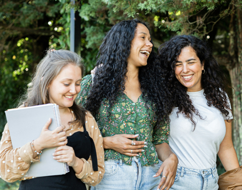 Three women walking and laughing together