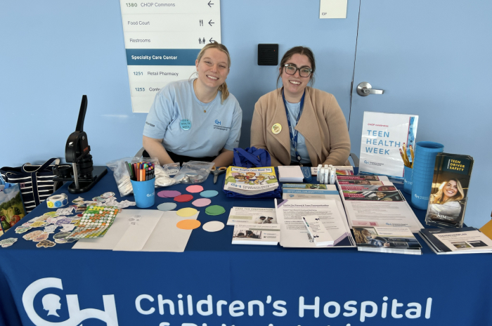 PolicyLab team members Madeline DeMarco and Kathryn Saulinas
                share resources during Teen Health Week.