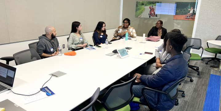 College students sitting in a conference room at Research Day event