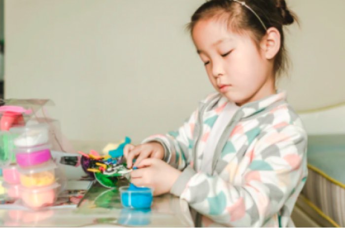 Asian Girl Playing with Toys