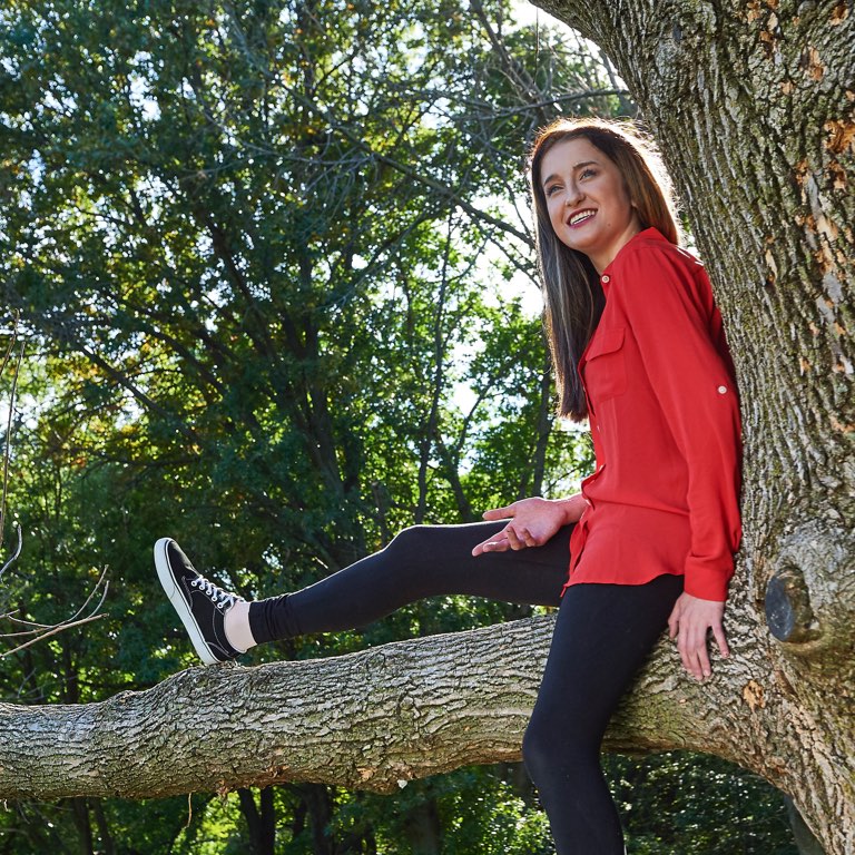 Teen Girl Sitting in Tree