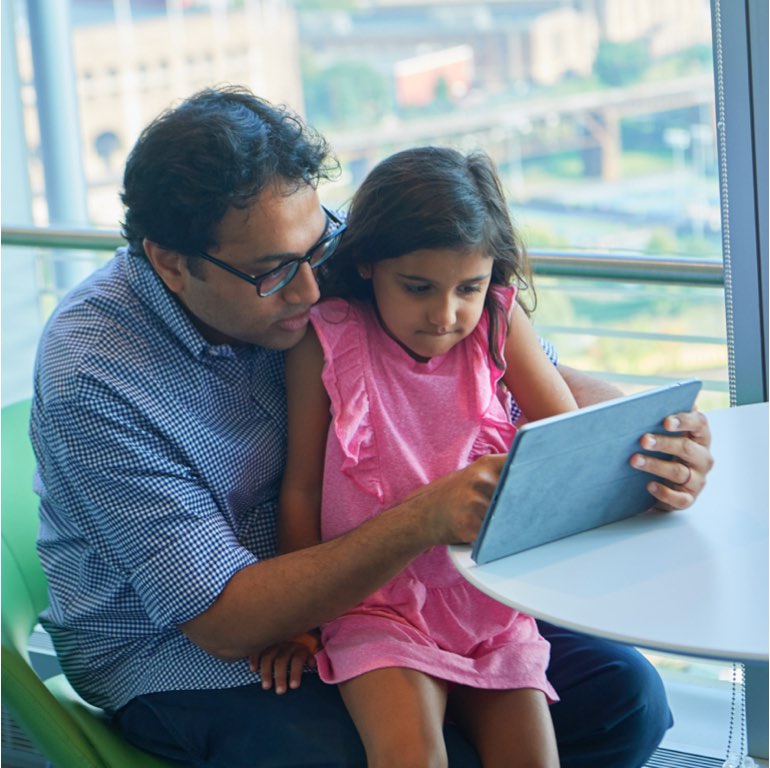 Father and Daughter Looking at iPad