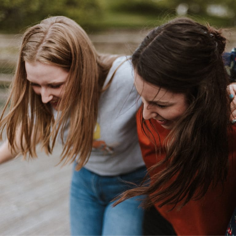 Teen Girls Laughing and Walking Together