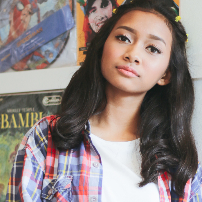 Teen Staring Ahead with Posters in Background