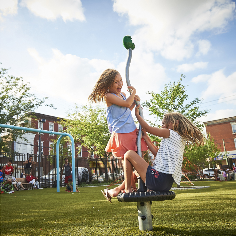 Two Young Girls Playing Outside on Playground