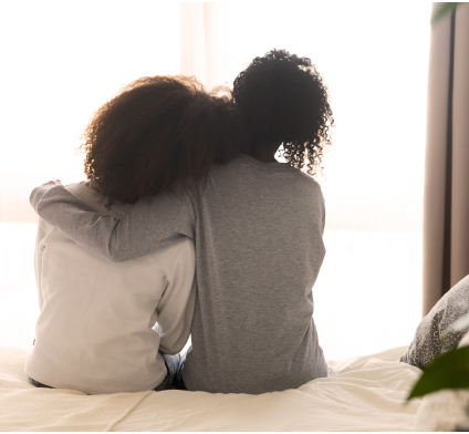 Adult Sitting With Arm Around Teen