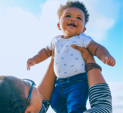 Black Mother Holding Smiling Baby