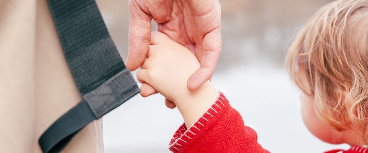 child and father holding hands