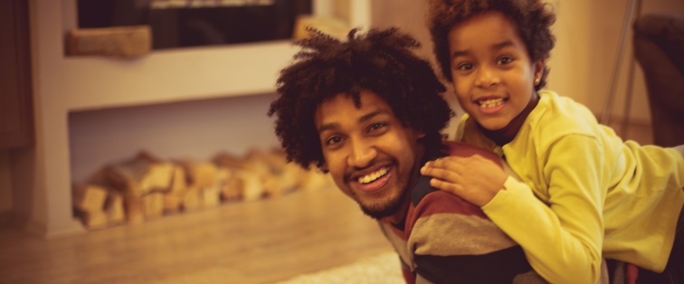 son laying down on father's back