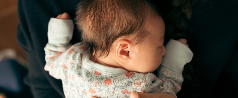 mother holding young baby