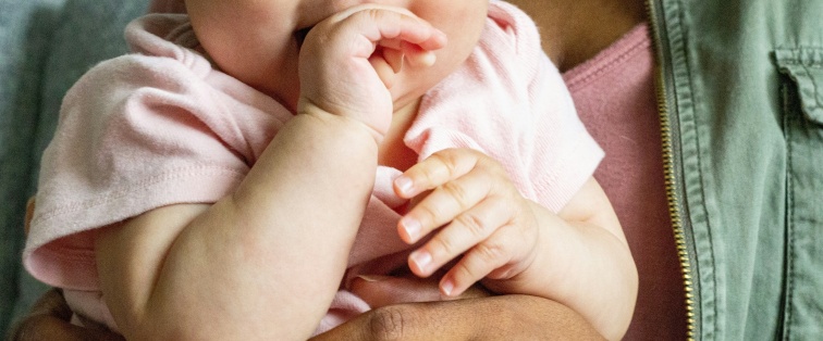 mother holding young baby