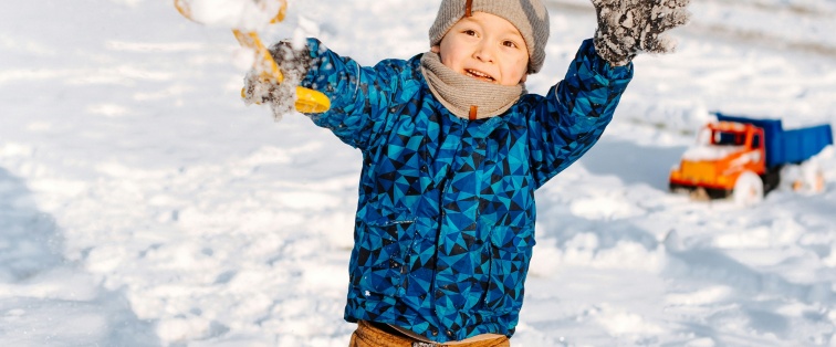 kid playing in the snow